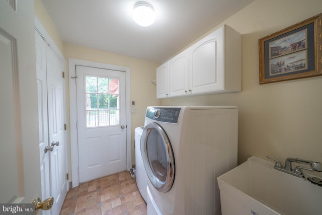 306 Springbrook Ct, Hockessin, DE 19707 - clothes washing area featuring cabinet space and stone finish flooring