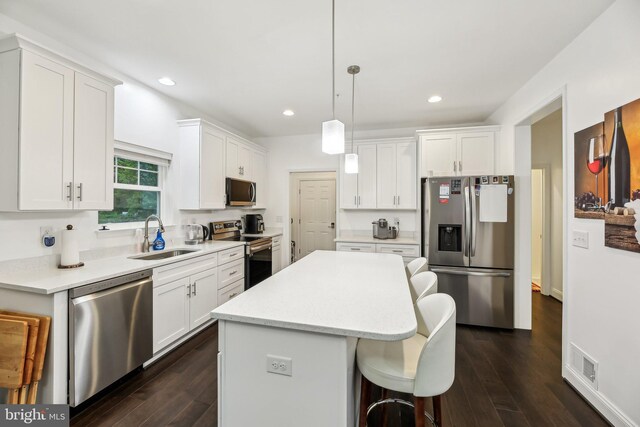 4202 Louisa Ave, Nottingham, MD 21236 - kitchen with stainless steel appliances, a sink, a kitchen island, white cabinets, and recessed lighting