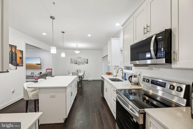 4202 Louisa Ave, Nottingham, MD 21236 - kitchen with appliances with stainless steel finishes, dark wood-type flooring, a sink, white cabinetry, and recessed lighting