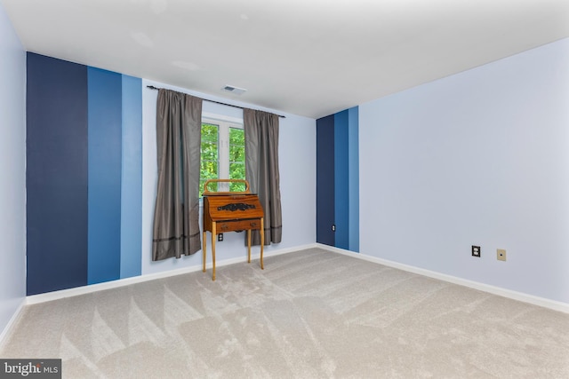 spare room with carpet and baseboards