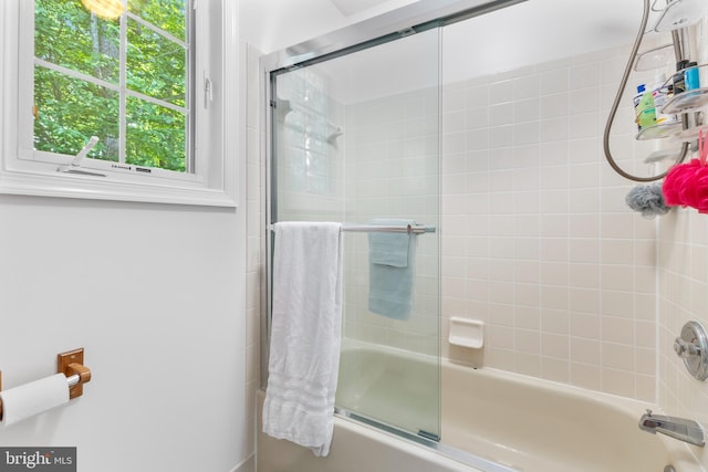 bathroom with shower / bath combination with glass door