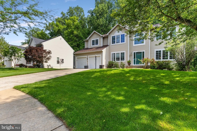view of front of house with a garage, driveway, and a front lawn