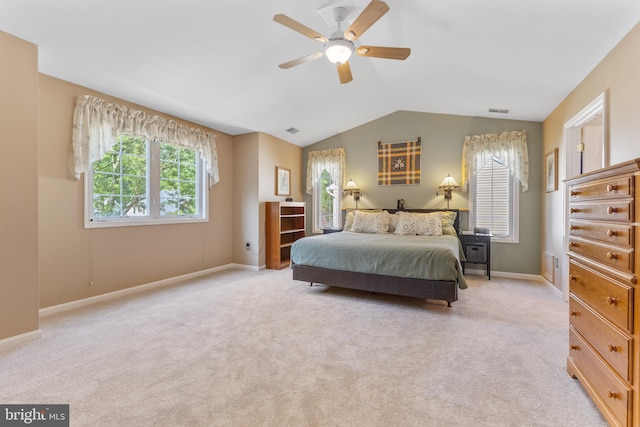 bedroom with multiple windows, lofted ceiling, light colored carpet, baseboards, and ceiling fan