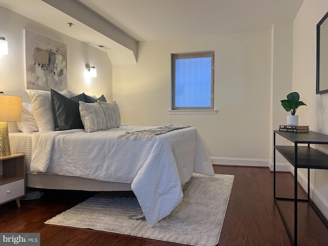 bedroom with wood finished floors and baseboards