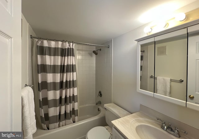full bath with toilet, shower / tub combo with curtain, and vanity