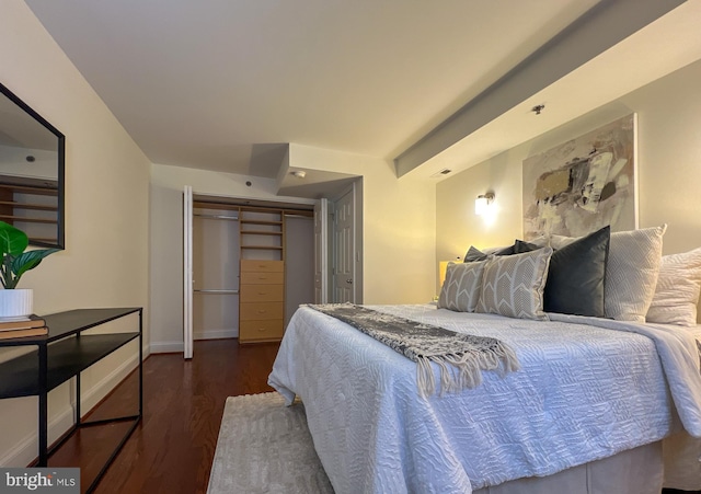 bedroom featuring wood finished floors, a closet, and baseboards