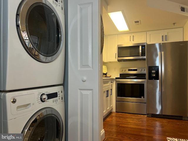 washroom featuring stacked washing machine and dryer and dark wood-style floors