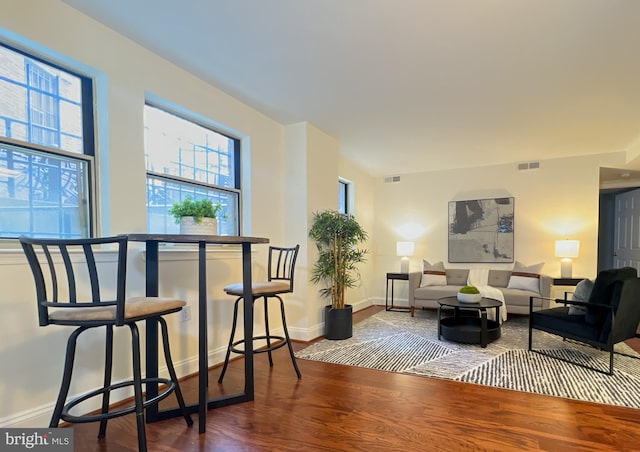 living area with wood finished floors and baseboards