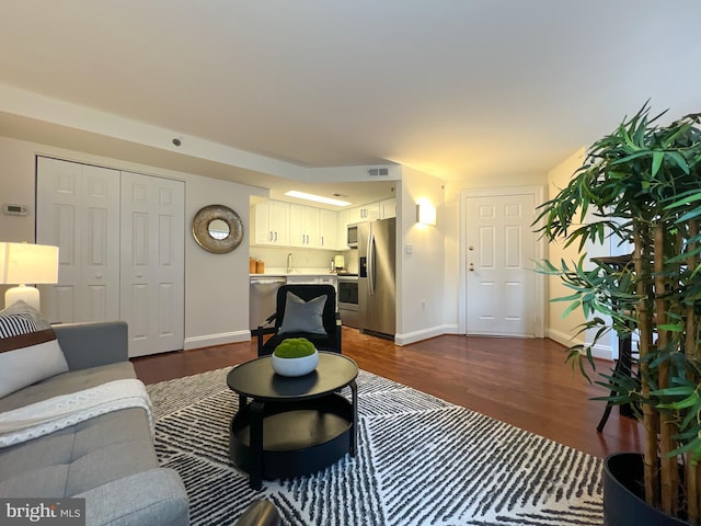 living room featuring dark wood-style floors and baseboards