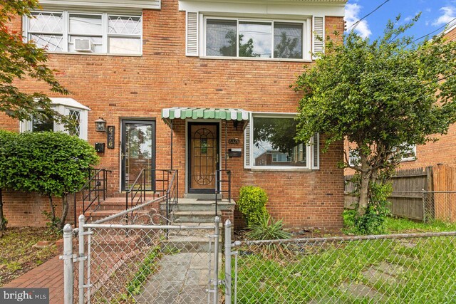 6328 N Capitol St NW, Washington, DC 20011 - view of property with a gate, a fenced front yard, and brick siding