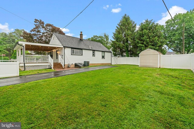 3082 Limekiln Pike, Glenside, PA 19038 - rear view of house featuring an outdoor structure, a shed, a chimney, a shingled roof, and central AC