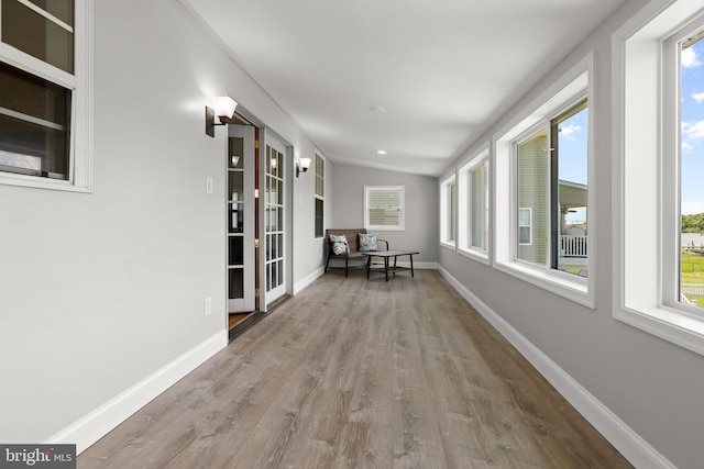 hall featuring wood finished floors and baseboards