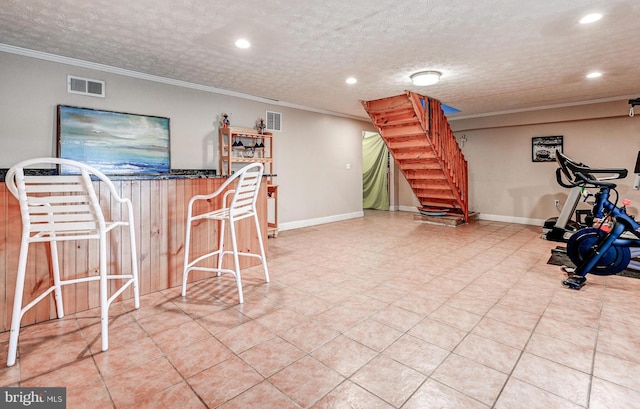 workout area with crown molding, recessed lighting, bar area, baseboards, and a textured ceiling