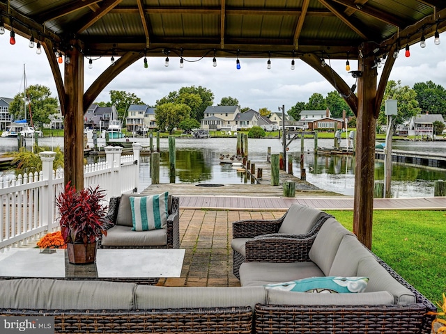 dock featuring a gazebo, outdoor lounge area, a water view, and a residential view