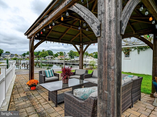view of patio / terrace with an outdoor hangout area, a gazebo, and a water view