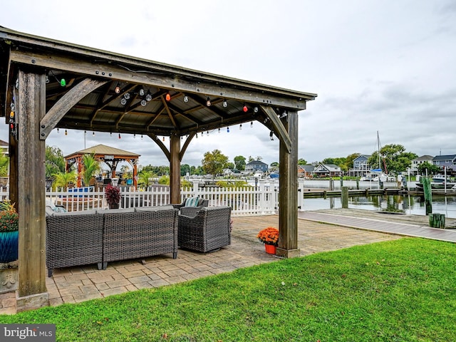 view of patio / terrace with a gazebo, an outdoor living space, and a water view