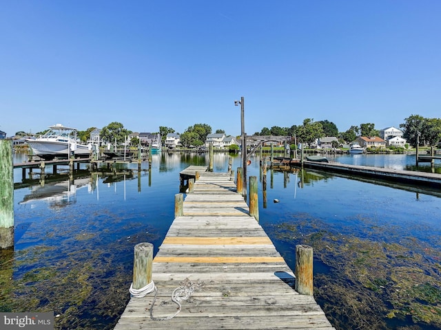 dock area with a water view and boat lift