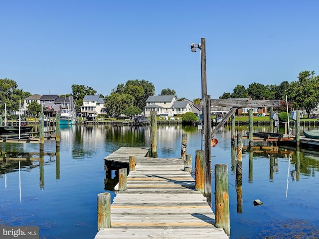 dock area with a water view and a residential view