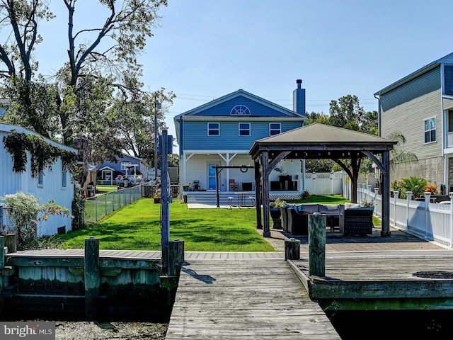 dock area featuring a gazebo, an outdoor hangout area, and a wooden deck