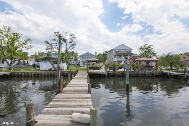 dock area with a gazebo and a water view