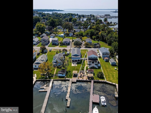 aerial perspective of suburban area with a nearby body of water