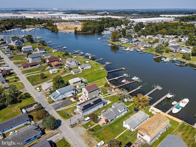 aerial view of property and surrounding area featuring a nearby body of water