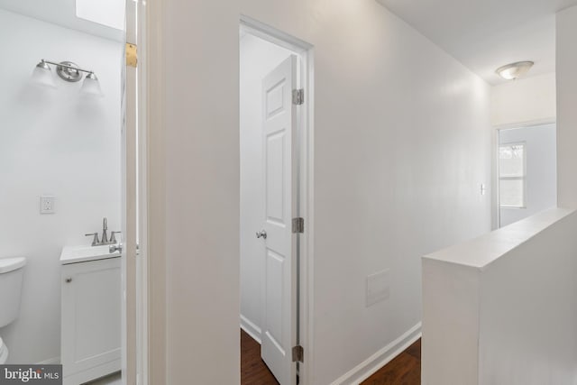 2514 Ashland Ave, Baltimore, MD 21205 - hallway featuring a sink and dark wood-style floors