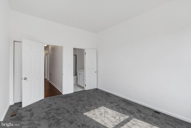 2514 Ashland Ave, Baltimore, MD 21205 - unfurnished bedroom featuring carpet, baseboards, and ensuite bath