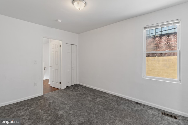 2514 Ashland Ave, Baltimore, MD 21205 - spare room with dark colored carpet, baseboards, and a smoke detector