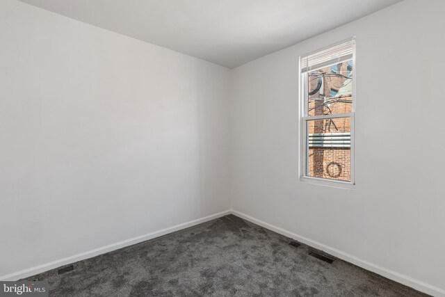 2514 Ashland Ave, Baltimore, MD 21205 - empty room featuring dark carpet and baseboards