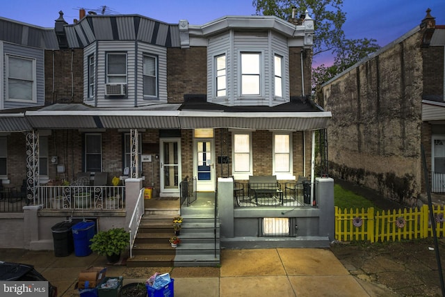2022 Rowan St, Philadelphia, PA 19140 - townhome / multi-family property with covered porch, brick siding, and cooling unit