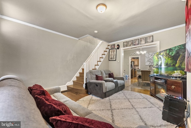 2022 Rowan St, Philadelphia, PA 19140 - living area featuring stairway, crown molding, wood finished floors, a chandelier, and baseboards