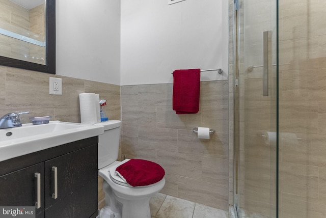 2458 N Natrona St, Philadelphia, PA 19132 - bathroom featuring tile walls, toilet, vanity, a shower stall, and tile patterned floors