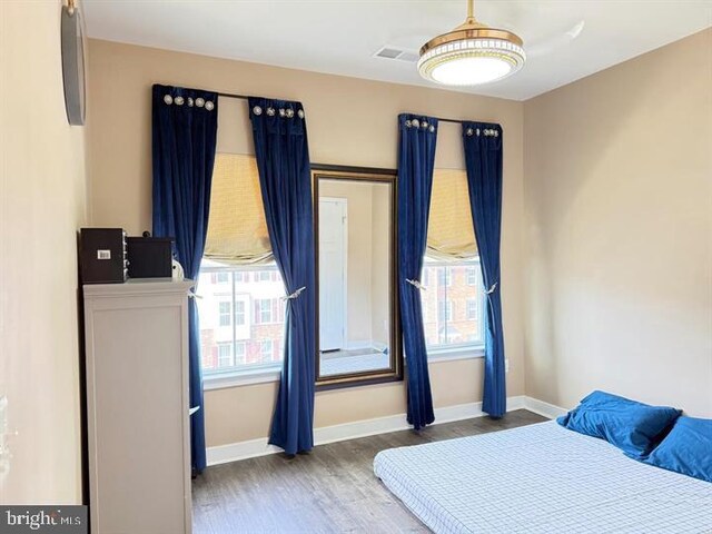 11237 Creek Ford Ter, Manassas, VA 20109 - bedroom with multiple windows, wood finished floors, and baseboards