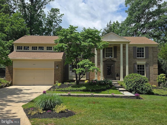 10814 Hob Nail Ct, Potomac, MD 20854 - view of front of home featuring concrete driveway, a front yard, brick siding, and a garage