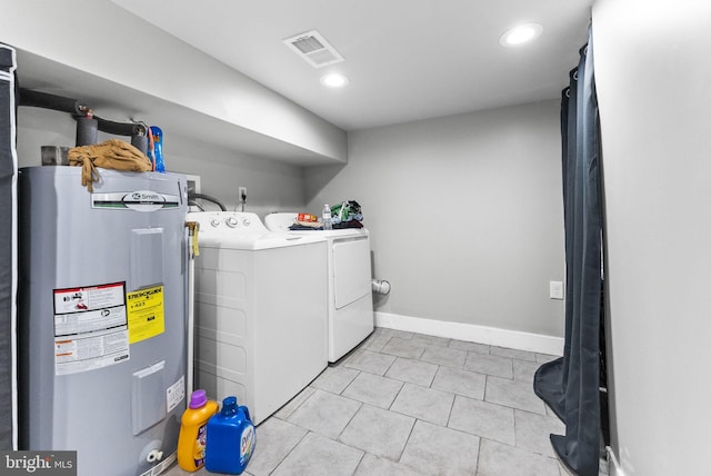 2460 N Natrona St, Philadelphia, PA 19132 - washroom with water heater, washer and clothes dryer, light tile patterned floors, baseboards, and recessed lighting