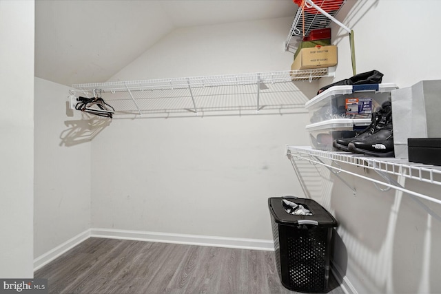 spacious closet featuring wood finished floors and lofted ceiling