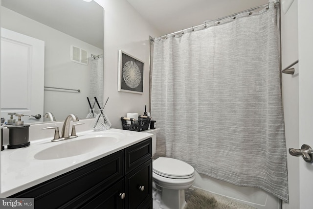 full bathroom with toilet and vanity