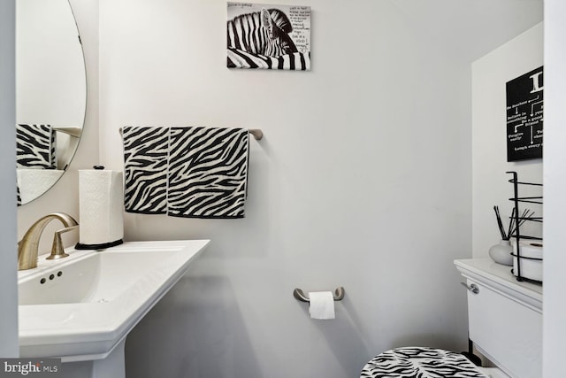 half bathroom featuring a sink