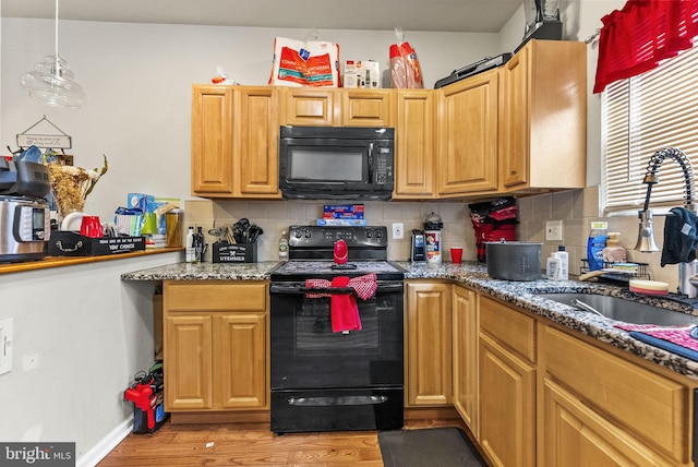 2466 N Natrona St, Philadelphia, PA 19132 - kitchen with black appliances, a sink, backsplash, and light wood-style flooring