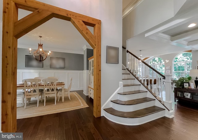 11372 Wollaston, Swan Point, MD 20645 - stairway featuring a chandelier, ornamental molding, wood finished floors, a decorative wall, and wainscoting