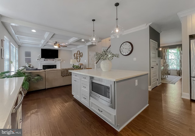 11372 Wollaston, Swan Point, MD 20645 - kitchen with stainless steel microwave, a ceiling fan, dark wood-style floors, coffered ceiling, and a fireplace