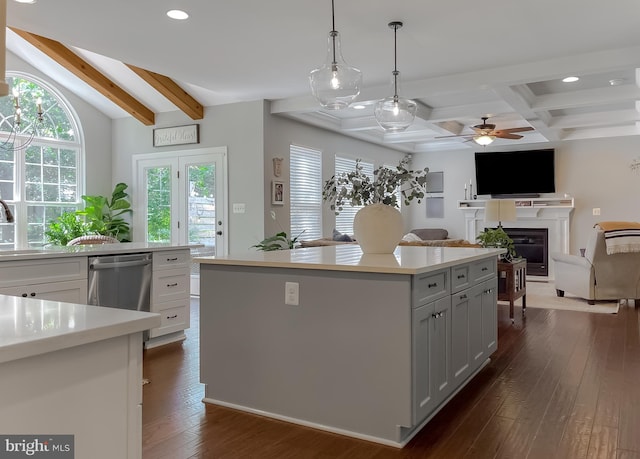 11372 Wollaston, Swan Point, MD 20645 - kitchen with beamed ceiling, recessed lighting, stainless steel dishwasher, a glass covered fireplace, and a kitchen island
