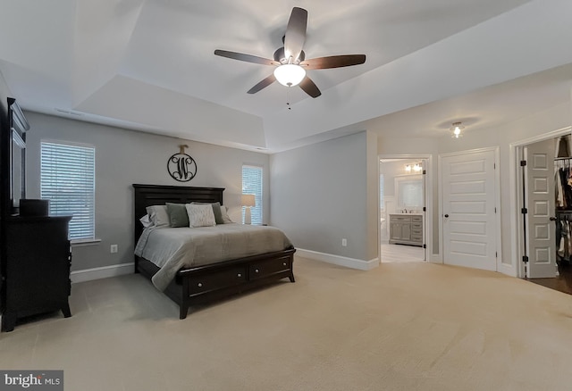 11372 Wollaston, Swan Point, MD 20645 - bedroom with a tray ceiling, baseboards, light carpet, ensuite bathroom, and ceiling fan