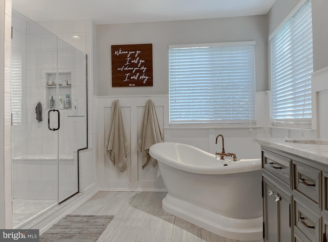11372 Wollaston, Swan Point, MD 20645 - full bath featuring a stall shower, a freestanding tub, vanity, and a wainscoted wall