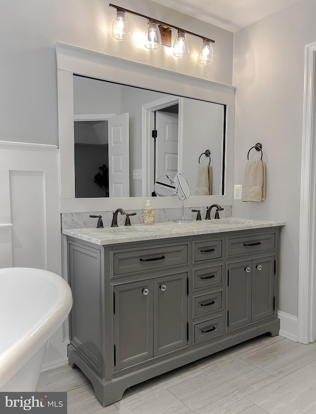 11372 Wollaston, Swan Point, MD 20645 - full bath with double vanity, a freestanding tub, and wood finished floors