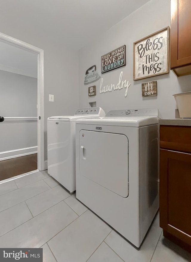 11372 Wollaston, Swan Point, MD 20645 - laundry area with washer and clothes dryer, cabinet space, and light tile patterned floors