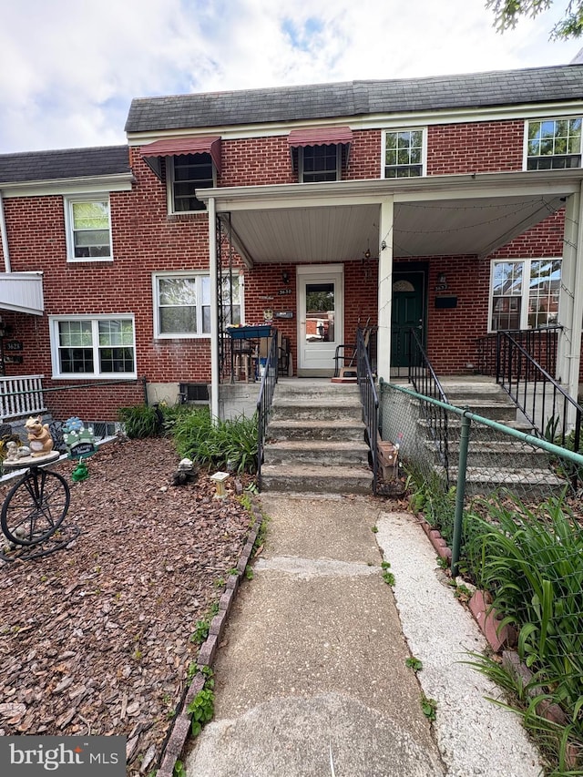3630 Keystone Ave, Baltimore, MD 21211 - townhome / multi-family property with brick siding, a porch, and roof with shingles