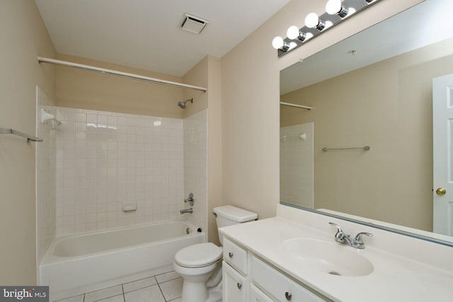 bathroom featuring tile patterned floors, toilet, vanity, and shower / tub combination