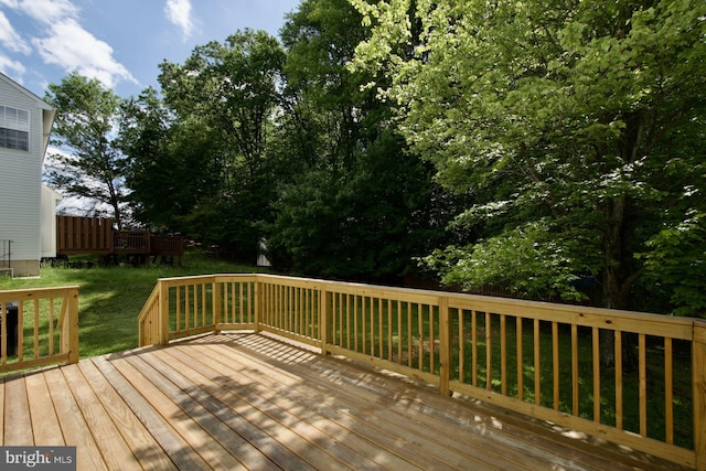 wooden terrace with a yard